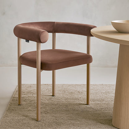 Ohio Velvet Dining Chair w/ Natural Legs Mocha Mousse Set of 2 features a curved brown faux leather backrest, matching cushion, and pale wooden legs, ideal for minimalist dining settings.