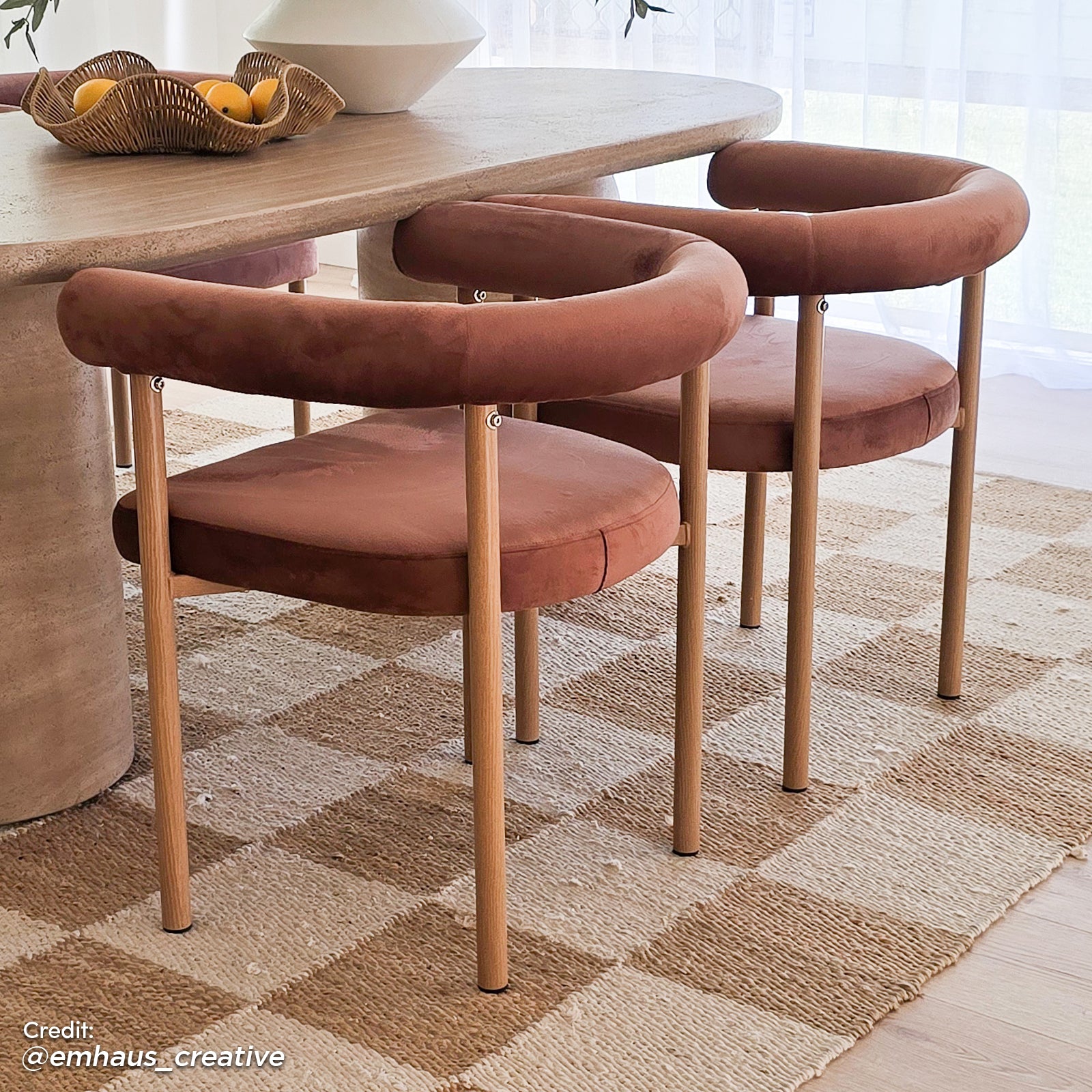 Ohio Velvet Dining Chair Set of 2 in Mocha Mousse & Oak, featuring tubular oak frames, terracotta velvet seats, and curved backrests, placed on a jute rug with a stone-like tabletop.