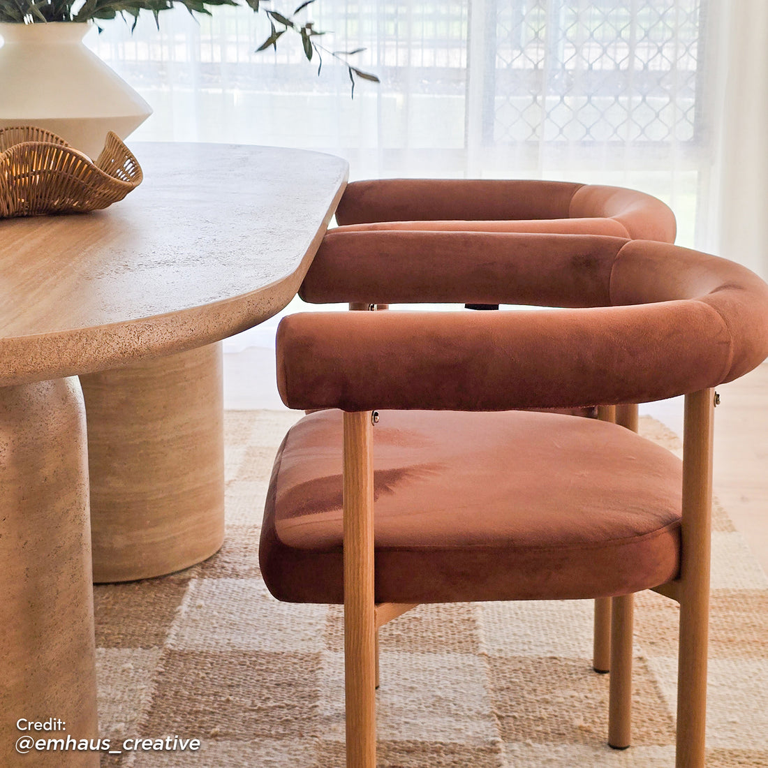 Ohio Velvet Dining Chair Set of 2 in Mocha Mousse & Oak displayed in a light dining nook with rust-colored velvet backs, oak-tone legs, under an oval table with stone-like top, on a woven rug.