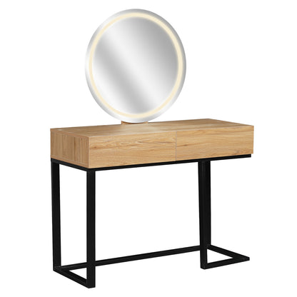 Ophira Dressing Table with Touch Screen Mirror Light – Oak features a light-wood tabletop with two drawers, a black metal frame with geometric legs, and a large round LED-lit mirror.