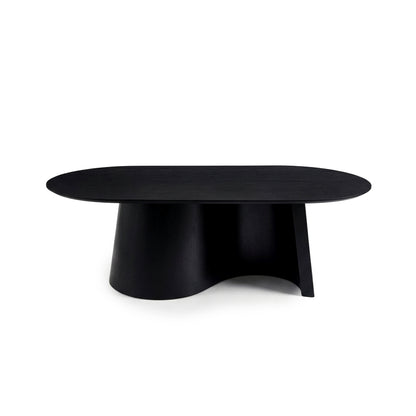 Full view of a black coffee table with oval top and sculptural curved base on a white background
