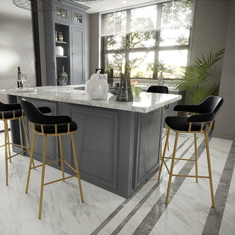 Piper Velvet Fabric Bar Stool Set of 2 in Black features black upholstered seats and slender gold-metal legs, accentuating a modern kitchen with a central white marble island and elegant decor.