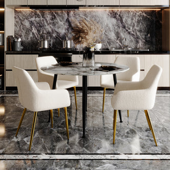 Raynie Dining Chairs with Gold Legs Set of 2 in Cream White, featuring plush bouclé upholstery and sleek gold legs, elegantly arranged around a round marble table in a modern kitchen-dining area.