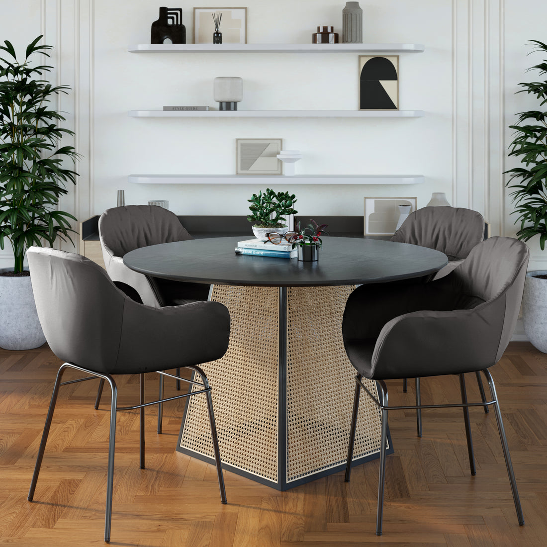 Rhea Suede Fabric Dining Chair Set of 2 in Black, featuring plush, padded seats with sleek metal legs, arranged around a round table with decorative books and plants, enhancing a modern dining nook.