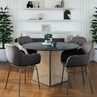 Rhea Suede Fabric Dining Chair Set of 2 in Black, featuring plush, padded seats with sleek metal legs, arranged around a round table with decorative books and plants, enhancing a modern dining nook.