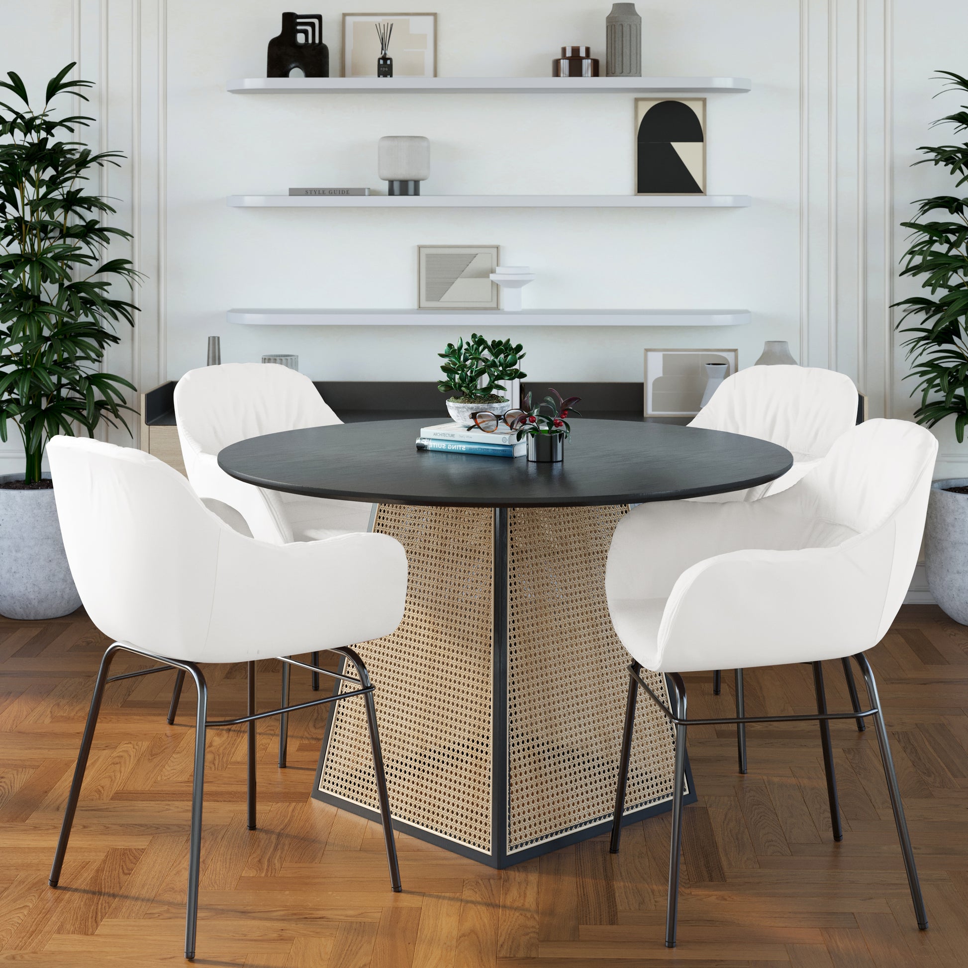 Rhea Suede Fabric Dining Chair Set of 2 in Cream White, featuring plush upholstery and slim dark metal legs, encircles a round black table with a rattan base in a stylish dining nook.