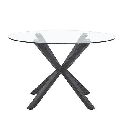 Rylee 120cm Black Round Table w/ 4 Halsa Chairs Dining Set features a glass top with intersecting X-shaped metal legs, paired with high-backed velvet chairs, creating a sleek, modern dining arrangement.
