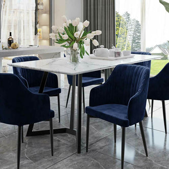 Salen 180cm White Marble Dining Table with a sleek marble top and distinctive geo design black metal legs, showcased in a stylish interior setting with a vase and plant accents.