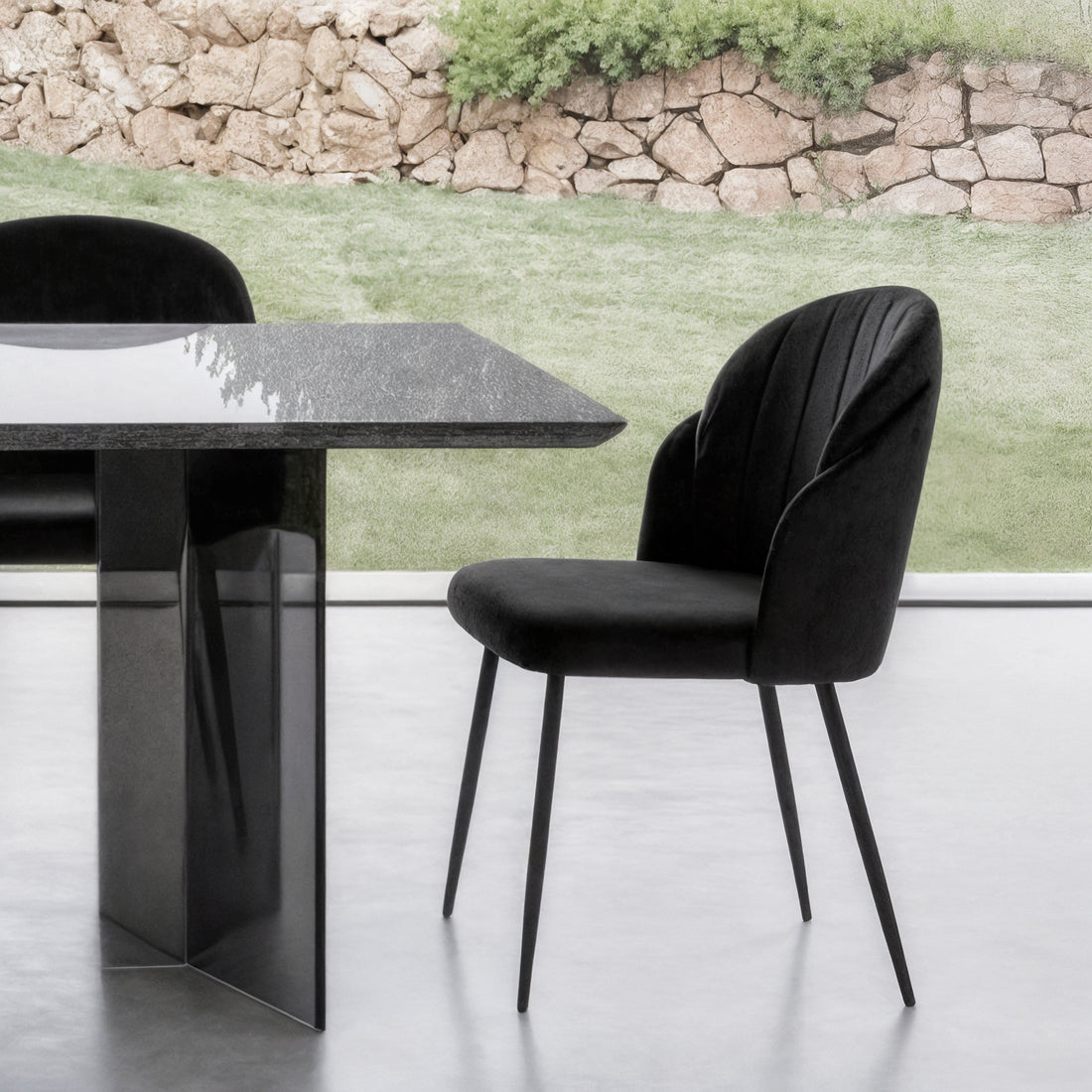 Scarlett Velvet Dining Chair Set of 2 in Black, featuring plush velvet upholstery and slender metal legs, paired with a matching black dining table with a polished stone top and pedestal base.
