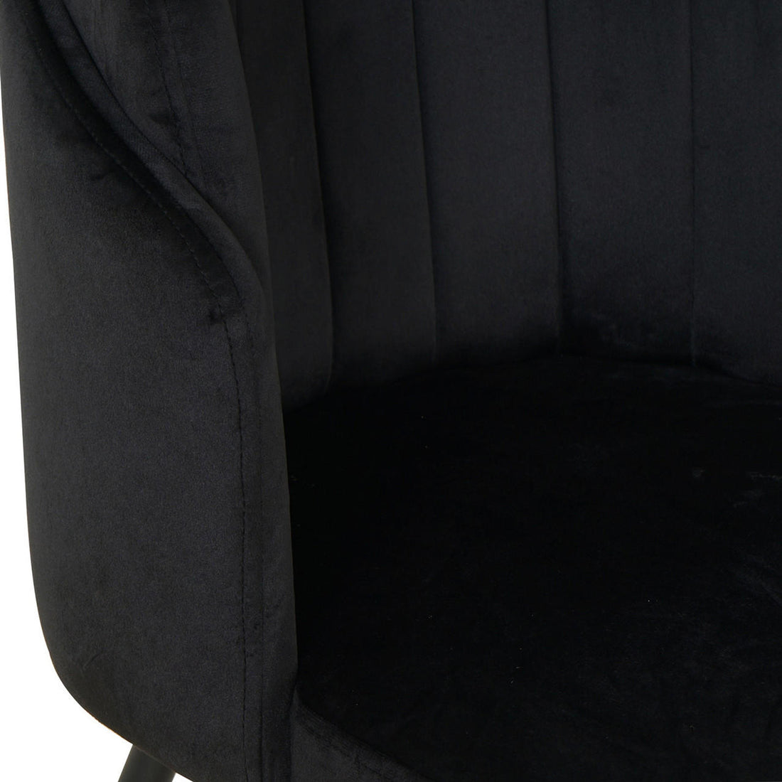Close-up of Scarlett Velvet Dining Chair Set of 2 in Black, showcasing the plush velvety fabric on the cushioned backrest and curved armrest, highlighting luxurious comfort and modern design.