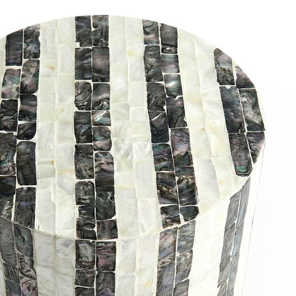 Close-up of cylindrical table’s mosaic inlay on white background