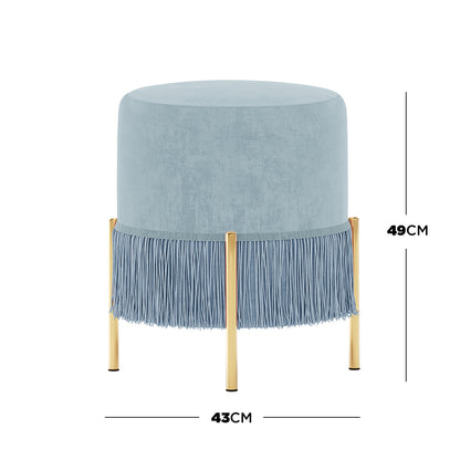Stacey Tassled Velvet Ottoman Foot Stool in Blue features soft pale-blue upholstery with fringe trim and gold-finished legs, blending elegance and functionality in a compact design.