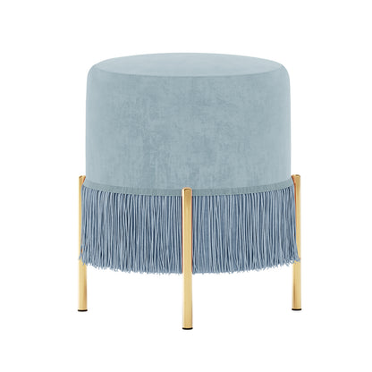 Stacey Tassled Velvet Ottoman Foot Stool in Blue, featuring pale-blue velvet upholstery with fringe, four gold-tone cylindrical legs, and plush padding, ideal for adding elegance and functionality to any room.