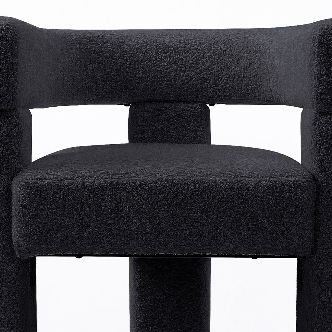 Utah Bouclé Curved 3 Legged Accent Chair in Black featuring a squared, padded seat, matching tubular support, and a high backrest, showcasing its modern design and plush upholstery.