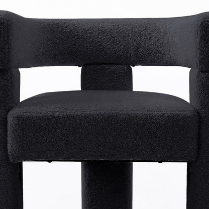 Utah Bouclé Curved 3 Legged Accent Chair in Black featuring a squared, padded seat, matching tubular support, and a high backrest, showcasing its modern design and plush upholstery.