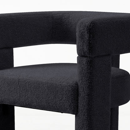 Utah Bouclé Curved 3 Legged Accent Chair in Black featuring a modern tubular design with textured bouclé fabric, showcasing part of the curved backrest, rounded seat, and thick cylindrical supports.