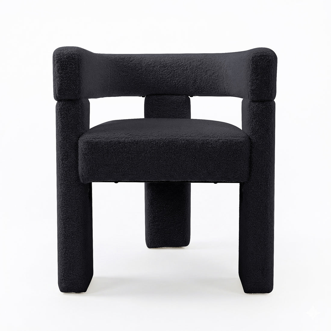 Utah Bouclé Curved 3 Legged Accent Chair in Black, featuring a geometric, block-like design with black bouclé upholstery. The chair's sculptural form includes a unique 3-legged silhouette, offering modern elegance.