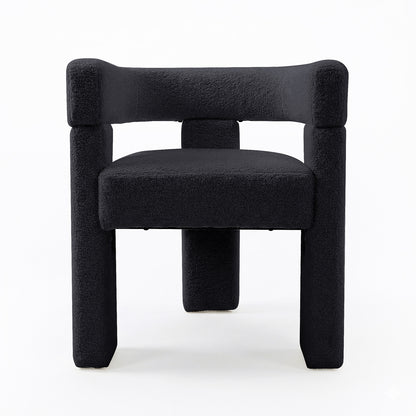 Utah Bouclé Curved 3 Legged Accent Chair in Black, featuring a geometric, block-like design with black bouclé upholstery. The chair's sculptural form includes a unique 3-legged silhouette, offering modern elegance.