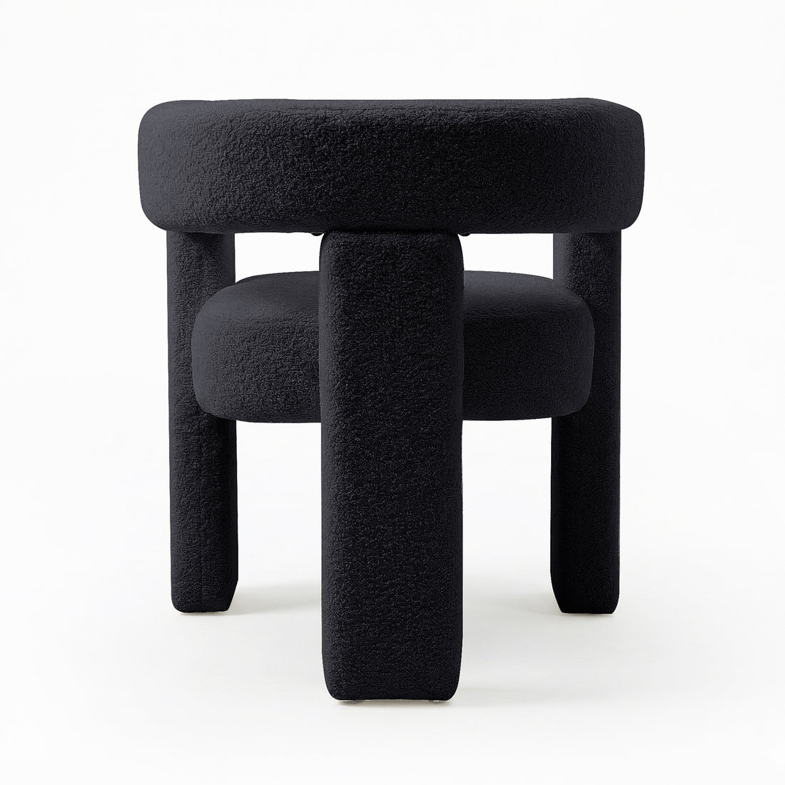 Utah Bouclé Curved 3 Legged Accent Chair in Black, featuring a modern, sculptural design with plush bouclé upholstery and three chunky cylindrical legs, offering both comfort and a striking focal point.