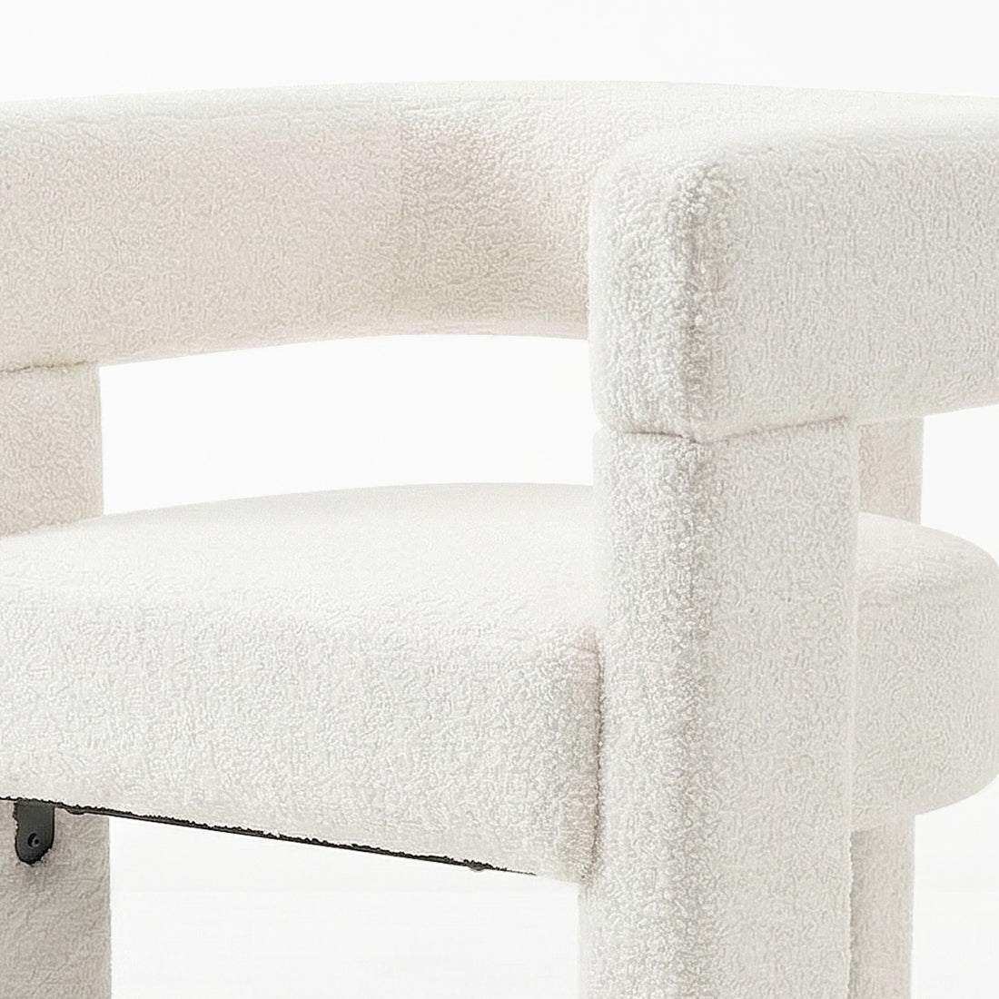 Utah Bouclé Curved 3 Legged Accent Chair in Cream, showcasing soft, nubby bouclé fabric, rounded seat, low curved backrest, and chunky cylindrical legs, creating a modern, ergonomic focal point.