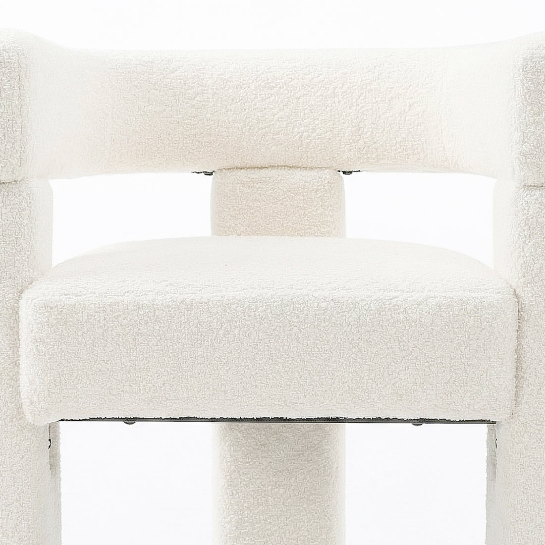 Utah Bouclé Curved 3 Legged Accent Chair in Cream features a close-up of its white boucle upholstery, showing a thick seat cushion and tubular backrest support, highlighting its modern design.