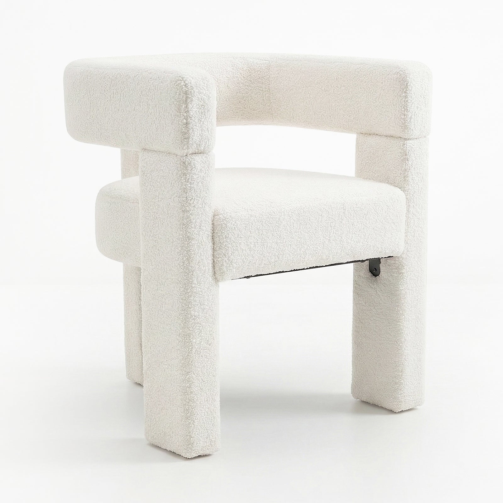 Utah Bouclé Curved 3 Legged Accent Chair in Cream features a chunky, curved backrest and unique three-legged design, upholstered in soft, textured bouclé fabric, offering sophisticated style and ergonomic comfort.