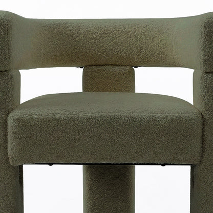 Close-up of the Utah Bouclé Curved 3 Legged Accent Chair in Green, showcasing its textured neutral-tone fabric upholstery, padded seat, and modern cylindrical support legs for stylish and ergonomic comfort.