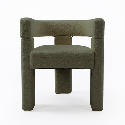 Utah Bouclé Curved 3 Legged Accent Chair in Green, featuring a geometric design with tubular legs and a textured fabric. Its sculptural form and ergonomic backrest offer a modern, minimalist aesthetic.