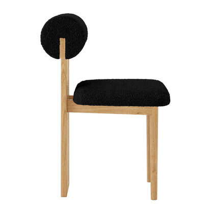Side profile of Wylie Boucle Oak Dining Chair Black Set of Two, featuring plush boucle upholstery, wooden legs, and a cushioned seat for modern dining comfort.