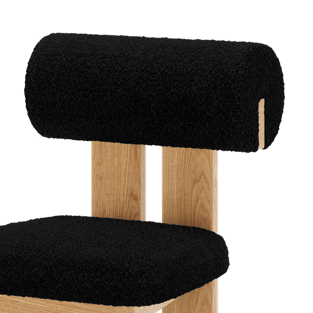 Close up of Wylie Boucle Oak Dining Chair Black Set of Two, featuring plush boucle upholstery, wooden legs, and a cushioned seat for modern dining comfort
