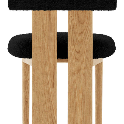 Wylie Boucle Oak Dining Chair (Set of Two) features a solid oak frame with a plush black cushion, showcasing modern design and craftsmanship.