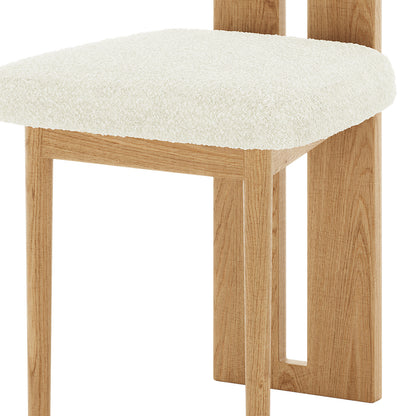 Close-up of Wylie Boucle Oak Dining Chair Cream White Set of Two, featuring a plush boucle fabric upholstery and solid American oak frame, showcasing a blend of comfort and modern design.