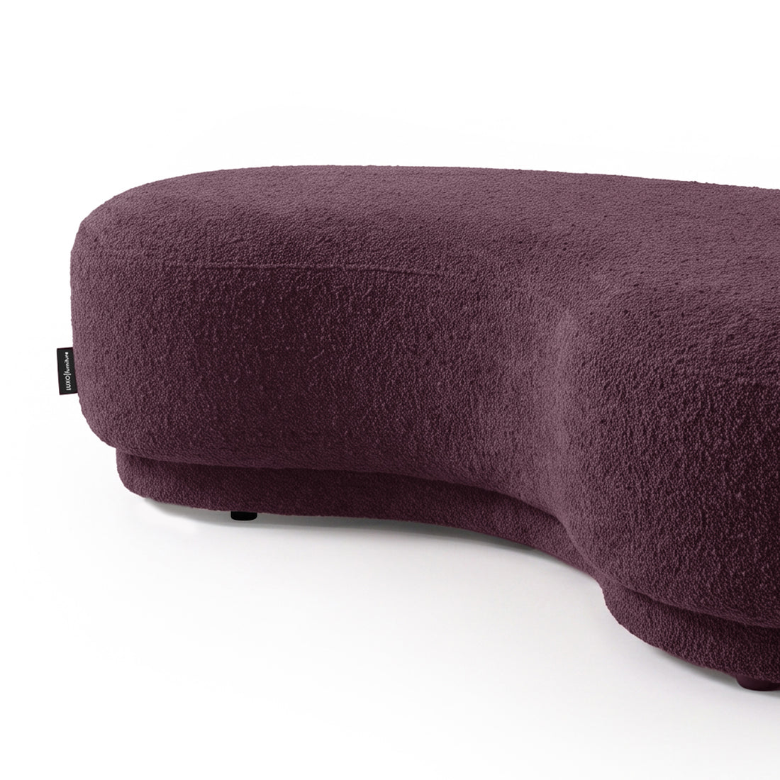 Kidney-bean shaped upholstered seating in rich plum color on a white background