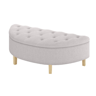 Amina Half Round Linen Fabric Ottoman in Warm Grey, showcasing a crescent shape with tufted top and four short wooden legs, upholstered in pale fabric, designed for extra seating or decor.