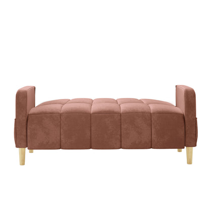 Anica 2 Seater Velvet Fabric Sofa Bed in Blush, showcasing a low, tufted design with removable arm-rests, upholstered in padded squares, and supported by short light-wood legs.