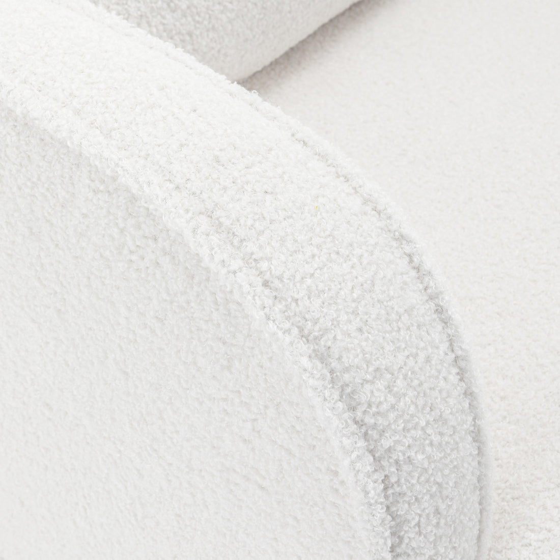 Close-up of Aura Bouclé Rocking Chair with Ottoman in Cream White, showcasing its rounded armrest and seat cushion upholstered in soft, textured bouclé fabric, representing modern elegance and comfort.