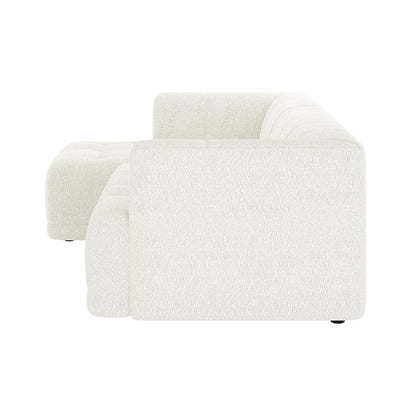Averill 4 Seater Boucle Fabric Chaise Sofa in Light Beige, featuring an L-shaped design with low arms, deep tufted cushions, and a matching ottoman, epitomizes modern minimalism and comfort.