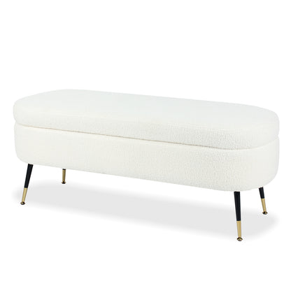 Bella 114cm Boucle Ottoman with Storage in Cream White, featuring a long oval top with textured upholstery, slender black legs, and brass-toned feet, ideal for stylish, functional seating and storage.