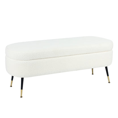 Bella 114cm Boucle Ottoman with Storage in Cream White, featuring a modern oval design with soft boucle fabric, supported by slender black legs with gold-tone tips, offering both style and practicality.