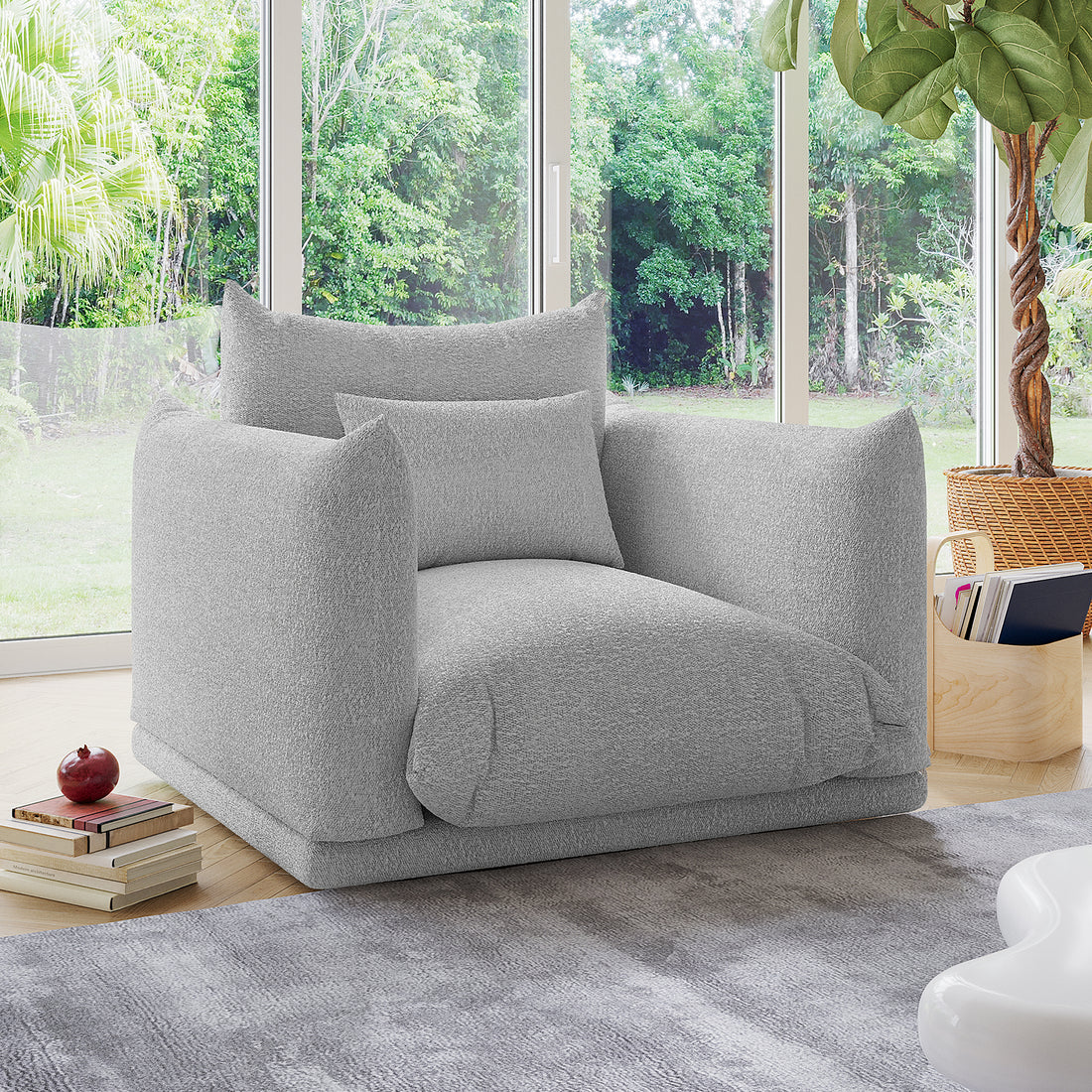 Berlin Single Seater Boucle Sofa with Pillow in Grey, oversized and plush, sits in a bright living room with textured upholstery, offering cozy seating amidst modern decor and lush outdoor views.