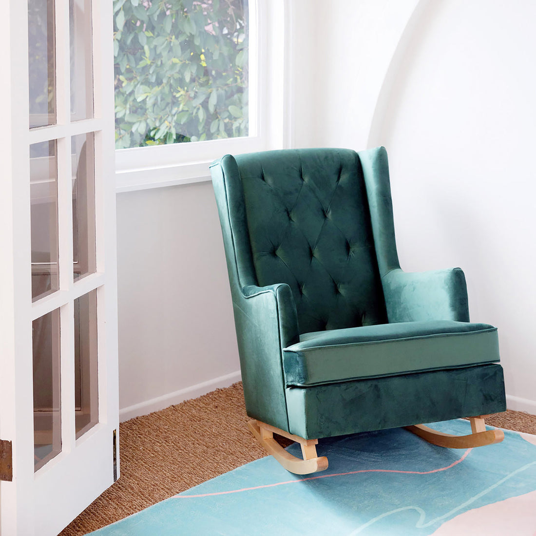 Brandt 2-in-1 Convertible Rocking Armchair in a corner, showcasing its plush velvet upholstery and button-tufted wingback, designed for both rocking and stationary use, with solid pine wood legs.