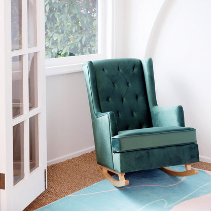 Brandt 2-in-1 Convertible Rocking Armchair in a corner, showcasing its plush velvet upholstery and button-tufted wingback, designed for both rocking and stationary use, with solid pine wood legs.