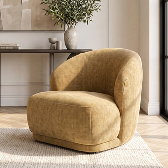 Mustard gold accent chair styled in a bright living room.