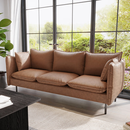 Cassian 3 Seater PU Leather Sofa in chocolate brown, featuring plush cushions, sleek design, and sturdy steel legs, set in a modern living room with a dark wood coffee table and lush outdoor view.