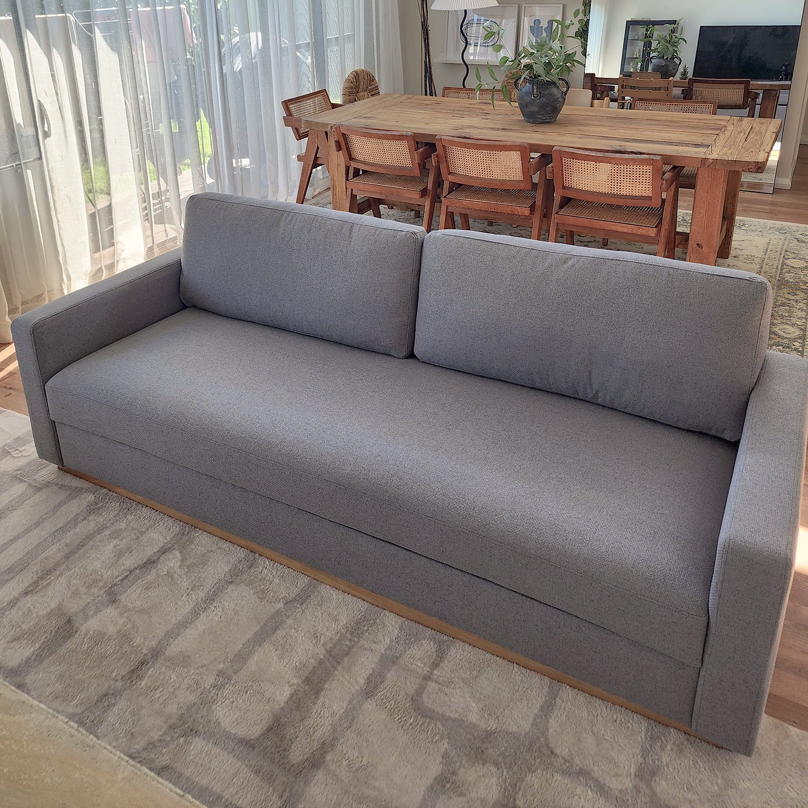 Celeste 3 Seater Hardwood Fabric Sofa Ash, displayed in a cozy room setting, showcasing its elegant rubber wood legs, removable cushions, and sturdy frame for modern living room comfort.