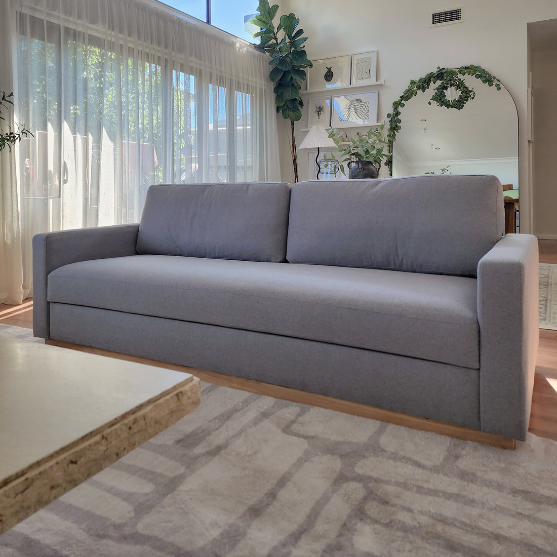 Celeste 3 Seater Hardwood Fabric Sofa Ash in a modern living space, showcasing its plush, removable cushions, sturdy rubber wood legs, and durable polyester linen fabric, emphasizing comfort and style.