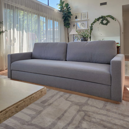 Celeste 3 Seater Hardwood Fabric Sofa Ash in a modern living space, showcasing its plush, removable cushions, sturdy rubber wood legs, and durable polyester linen fabric, emphasizing comfort and style.