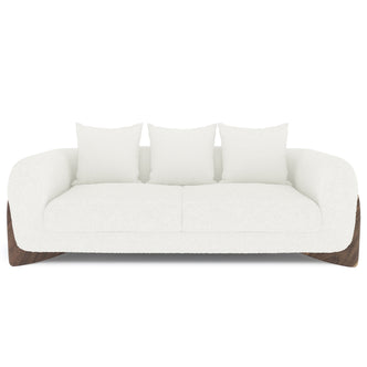 Charla 3-Seater Boucle Sofa in Cream White, featuring a modern design with gently rounded arms, textured fabric upholstery, sculpted wooden base, and three matching throw pillows for added comfort.