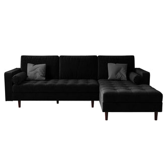 Claude 3 Seater Velvet Sofa with Chaise – Black, featuring plush cushions and a spacious chaise, showcased in a living room setting with matching round pillows, highlighting its luxurious and comfortable design.