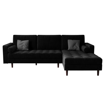Claude 3 Seater Velvet Sofa with Chaise – Black, featuring plush cushions and a spacious chaise, showcased in a living room setting with matching round pillows, highlighting its luxurious and comfortable design.